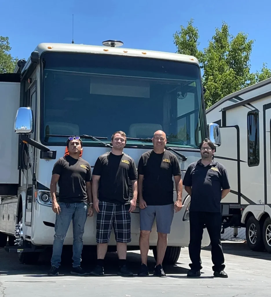 The California RV Glass crew standing in front of a Class A motorhome