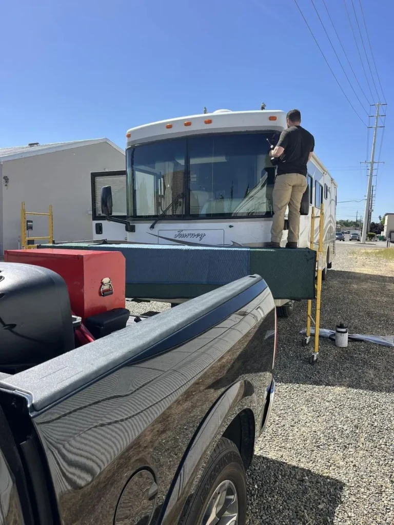 RV windshield work on a motorhome, seen from the service truck
