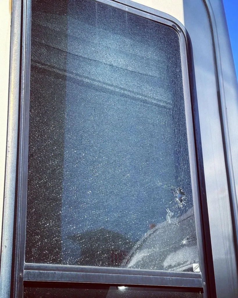 Shattered RV side window before tempered glass replacement