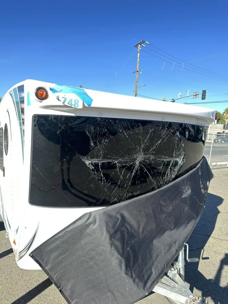 Travel trailer with a shattered front window before replacement